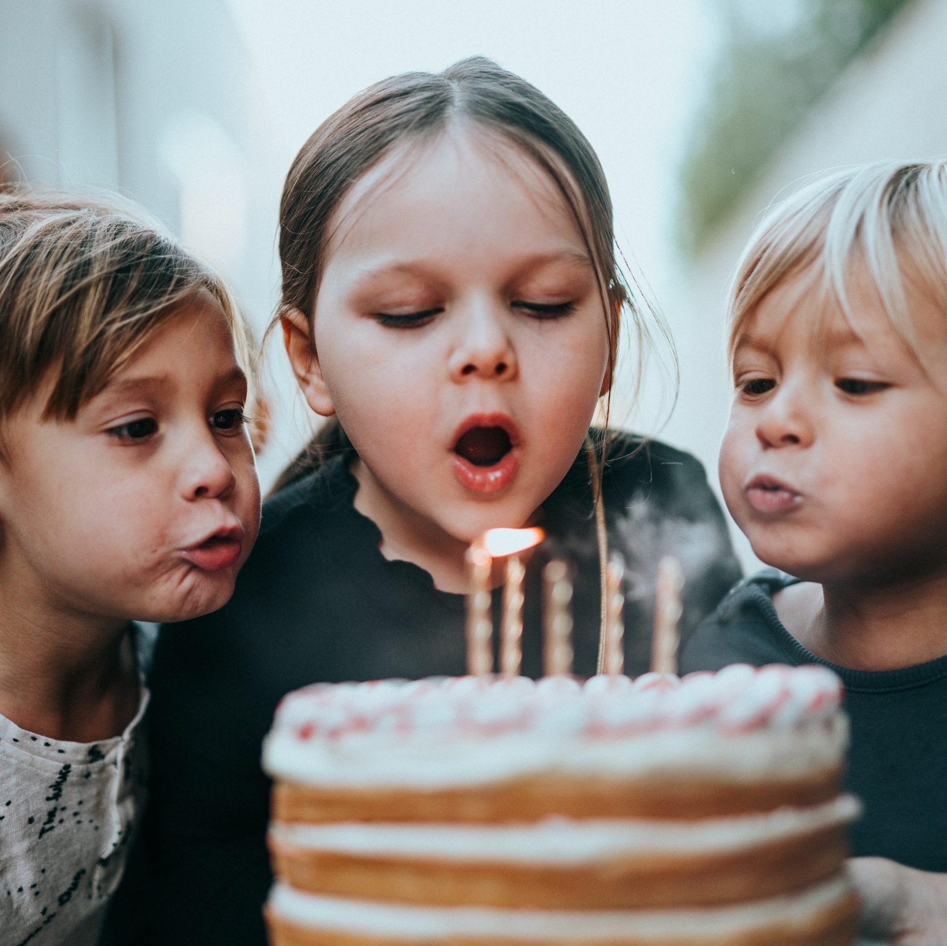 boy and girl blowing candles